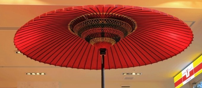 酒店前台旁漂亮的红伞，支撑部分是用毛线编织的。